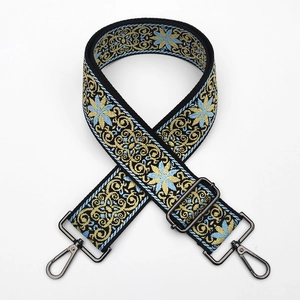 Detail of 5cm wide ethnic jacquard bag strap with blue floral embroidery and metal hooks