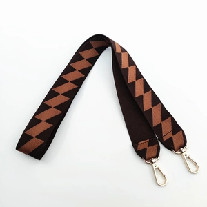 Wide woven shoulder strap with orange geometric pattern and gold swivel lobster clasps