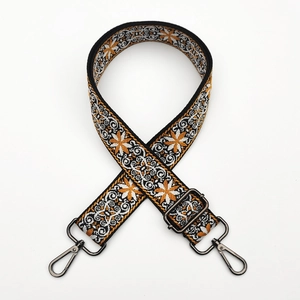 Close-up of ethnic jacquard shoulder strap with star patterns and metal lobster clasps