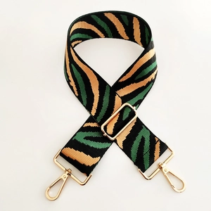 Adjustable zebra print wide shoulder strap with golden metal swivel hooks and buckles