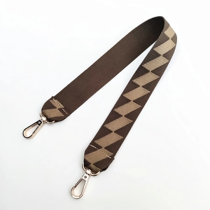 Close-up of brown geometric wide shoulder strap with gold-tone metal lobster clasps