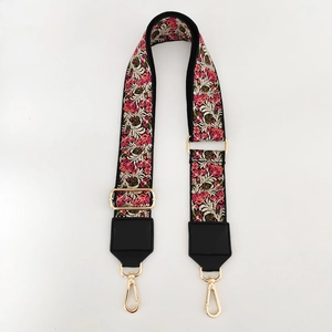 Detailed view of ethnic floral embroidered wide strap with premium golden metal hooks
