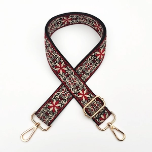 Close-up of ethnic jacquard shoulder strap with gold metal lobster clasps for bags