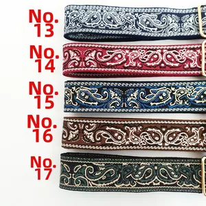 Detailed view of five ethnic paisley pattern embroidered bag straps with gold buckles