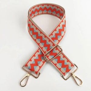 Adjustable wide replacement strap with orange and blue chevron pattern and gold buckles