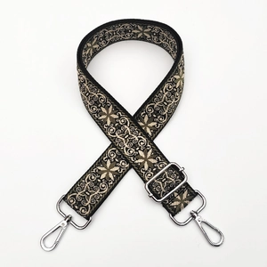 Detail of adjustable ethnic embroidery guitar style strap with silver metal hooks