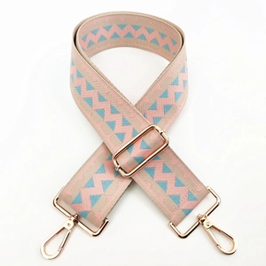 Close-up of a wide adjustable bag strap with pink and blue geometric wavy patterns