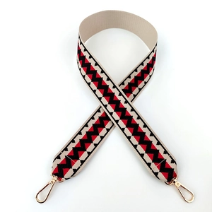 Close-up of geometric zigzag patterned cotton bag strap with light gold lobster clasps
