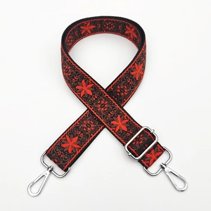 Detail showing vintage ethnic floral embroidery on a wide adjustable camera bag strap