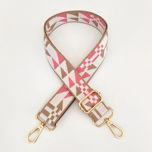 Close-up of pink and brown geometric woven bag strap with golden metal lobster clasps