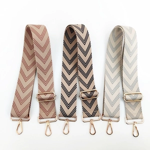 Adjustable colorful woven shoulder straps with gold hardware and herringbone pattern