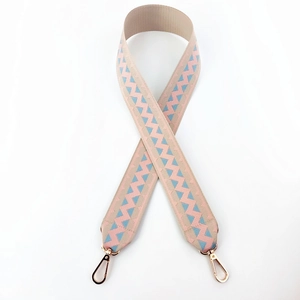 Close-up of pink and blue wave pattern woven bag strap with rose gold metal hooks