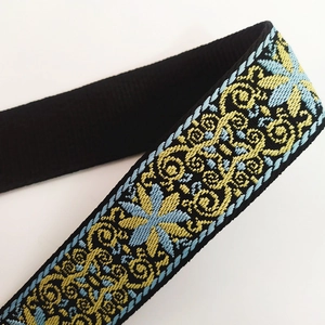 Detailed macro view of ethnic jacquard strap with intricate blue and yellow embroidery