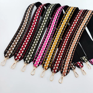 Detail of colorful zigzag weave bag straps with luxury gold-tone metal lobster clasps