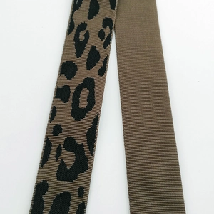Close-up of leopard print and solid brown woven strap textures for handbags