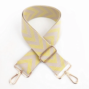 Detail view of yellow herringbone woven strap with light gold metal lobster clasps