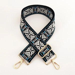 Close-up of ethnic geometric pattern jacquard strap with gold metal lobster clasps