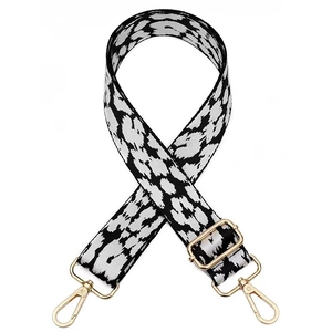 Adjustable wide replacement shoulder strap with black and white animal print and gold buckles