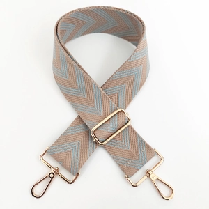 Adjustable canvas shoulder strap with khaki and blue herringbone pattern and gold hooks