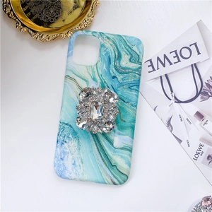 Detail of teal marble phone case featuring a luxury crystal rectangle gemstone grip