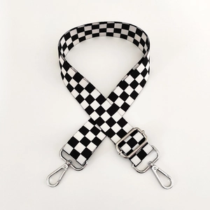 Detail of adjustable black and white checkerboard strap with silver metal lobster clasps