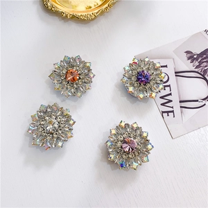 Detailed view of floral diamond phone grips in orange, purple, white, and pink crystals