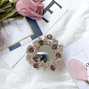 Sparkling crystal mirror phone grip in champagne gold with purple rhinestones detail
