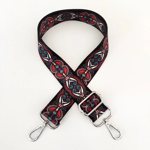 Detail of bohemian patterned bag strap with silver metal buckles and complex weaving