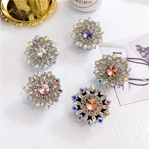 Macro detail of luxury crystal floral phone sockets in five vibrant colors with rhinestones