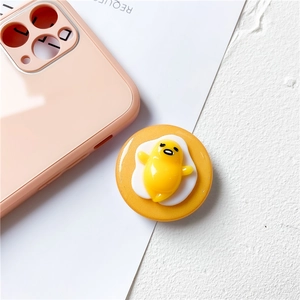 Detailed 3D Gudetama egg yolk phone socket attached to a pink mobile case