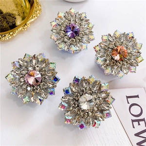 Detailed macro view of luxury diamond-encrusted flower-shaped cell phone socket holders