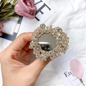 Close-up of sparkling rhinestone phone grip with a built-in mirror and refined silver finish