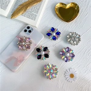 Floral rhinestone phone grip stand with crystal petals and pearl center in multiple colors
