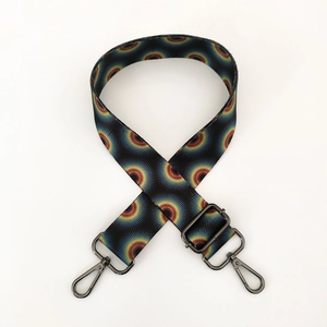 Detail of adjustable ethnic style wide strap with colorful solar pattern and black metal hooks