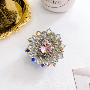 Detailed macro view of luxury diamond-encrusted floral phone grip with pink crystal center
