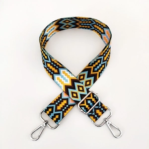 Close-up of colorful ethnic woven strap with geometric patterns and silver metal hooks