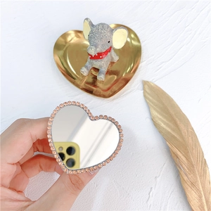 Close-up of heart-shaped phone grip with sparkling rhinestones and integrated mirror