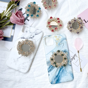 Detailed view of luxury marble phone case with diamond-encrusted mirror pop socket grip