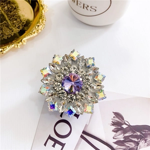 Macro detail of luxury flower phone grip with purple stones and shiny zircon crystals