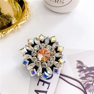 Close-up of luxury rhinestone phone socket with amber crystal and multi-color accents