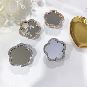 Macro shot of rhinestone flower phone grips with mirror surface and gold silver plating