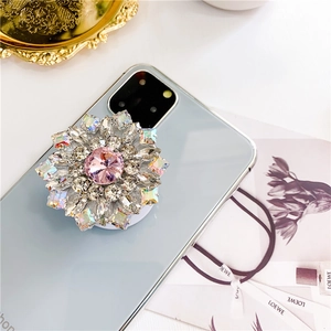 Macro view of luxury floral diamond phone grip with pink gemstone and sparkling crystals