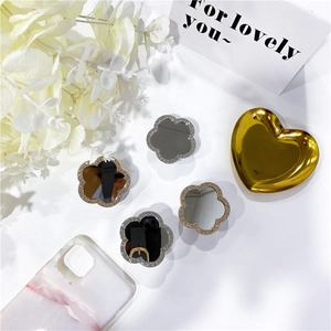 Close-up of sparkling floral diamond phone sockets with mirror center in gold and silver