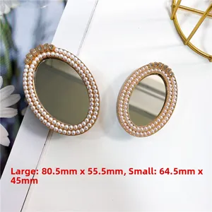 Detail view of large and small oval vanity mirrors with pearl and rhinestone edges