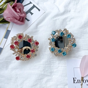 Close-up of sparkling rhinestone phone sockets with mirrors in red and blue crystal finish