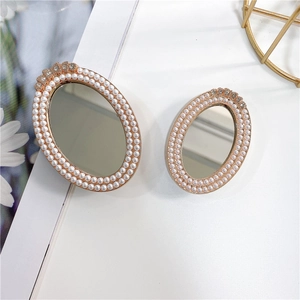 Oval makeup mirror phone socket with pearls and rhinestones on gold metallic frame