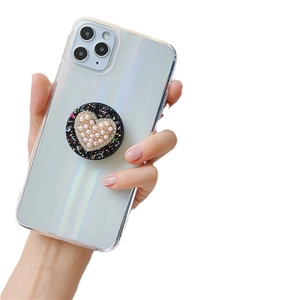 Retractable phone grip with shiny glitter base and a pearl heart-shaped decoration