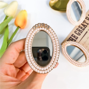 Elegant pearl and rhinestone oval mirror phone grip holder with vintage aesthetic