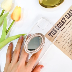 Detail view of oval mirror phone grip with faux pearl border and rhinestone accents