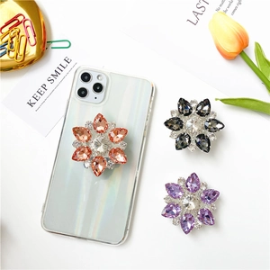 Supporto per telefono a fiore con strass colorati in arancione, grigio e viola